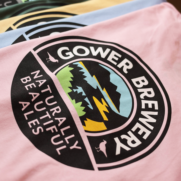 Gower Brewery t-shirt with logo and text on a pink background